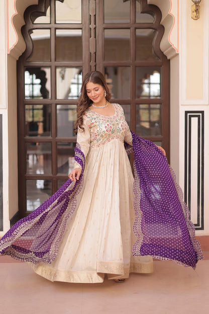 *Experience the allure of Trending Cosmos Jequard Gown With Bandhani Printed Embroidered Cut work Dupatta. Discover the perfect fusion of elegance and grace. Shop now for a timeless appearance.*